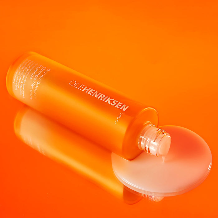 Open bottle of Barrier Booster Orange Ferment Vitamin C Essence laid down sideways.