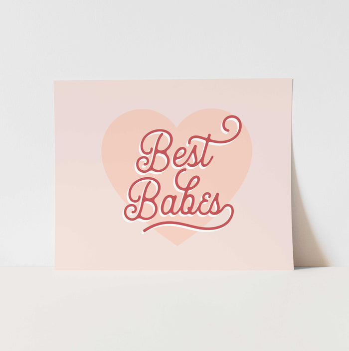 Heart-shaped sign with 'Best Babes' text on a light pink background