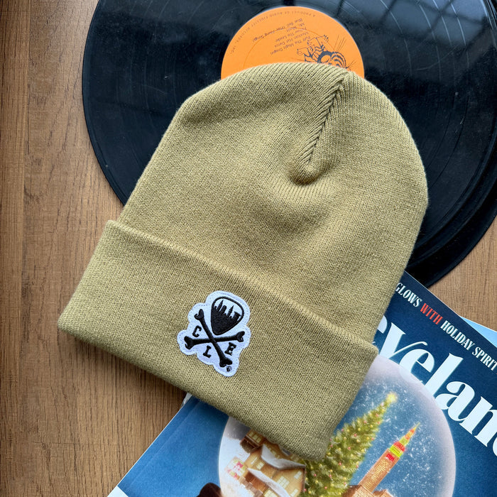 Beige beanie with a logo on a vinyl record and magazine