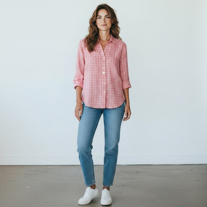 The FRANK & EILEEN - EILEEN Relaxed Button Up in Italian Linen Red and White Grid features a long-sleeve, collared design with slightly rolled sleeves and a relaxed fit. Expertly crafted from luxurious Italian linen, this shirt showcases bust-flattering button placement and a striking red and white grid pattern. The shirt is labeled “Frank & Eileen EST 1947.”.