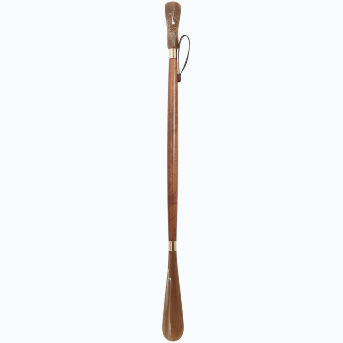 The HARVY CANES - ELEGANCE SHOE HORN by HARVY CANES is expertly handcrafted in Spain, featuring a long wooden body, curved end, slender handle, brass accents, and a leather hanging loop—showcasing classic European craftsmanship.