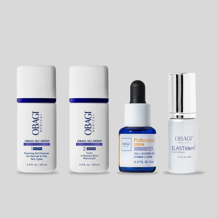 All Obagi products included in this kit on a gray background. This kit includes a gel cleanser, a toner, vitamin c serum 15%, and a facial serum.