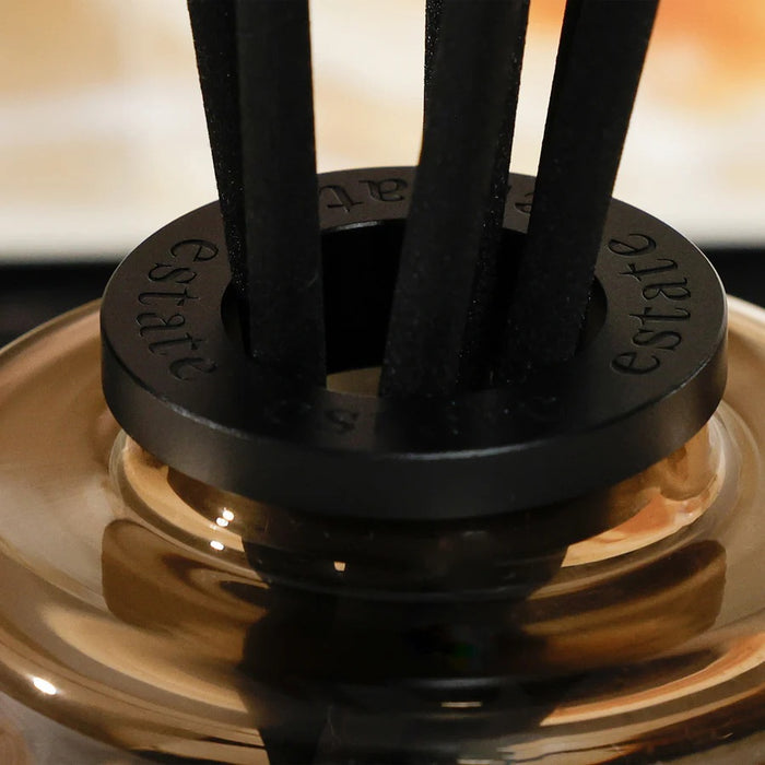 A black rectangular ZODAX gift box with a small label sits beside the THISTLE ESTATE DIFFUSER - 200 ML, featuring black reeds and scented liquid for a refreshing California coast fragrance.