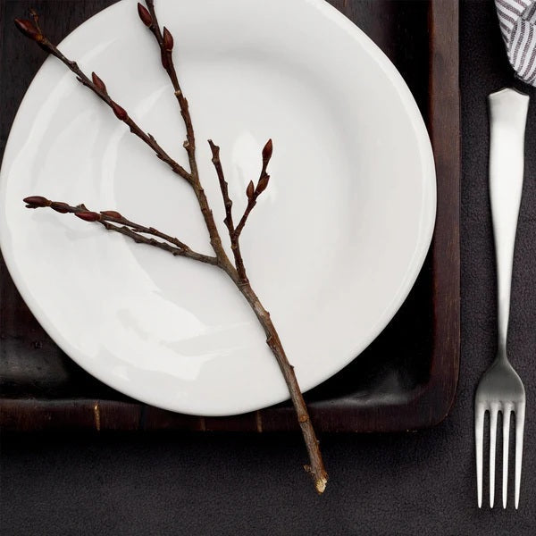 The VIETRI - FORMA CLOUD DINNER PLATE by VIETRI is a handcrafted white stoneware plate with subtly wavy, uneven edges, shown from above against a white background.