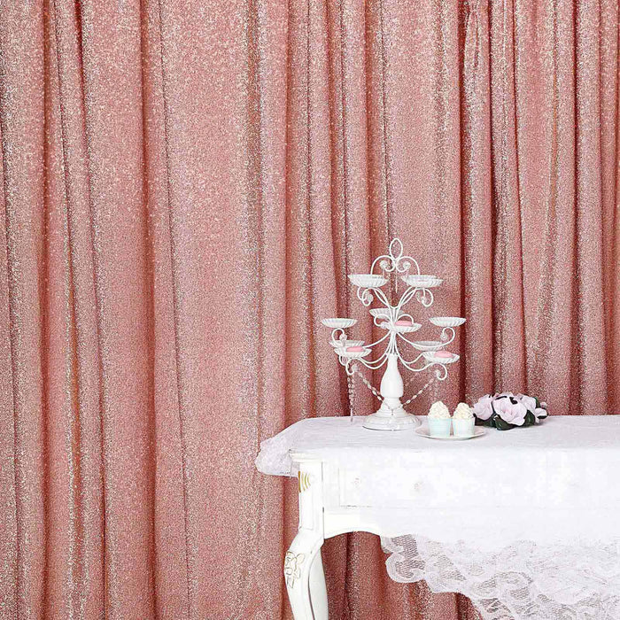 Elegant pink glitter backdrop with a white table and decorative centerpiece.