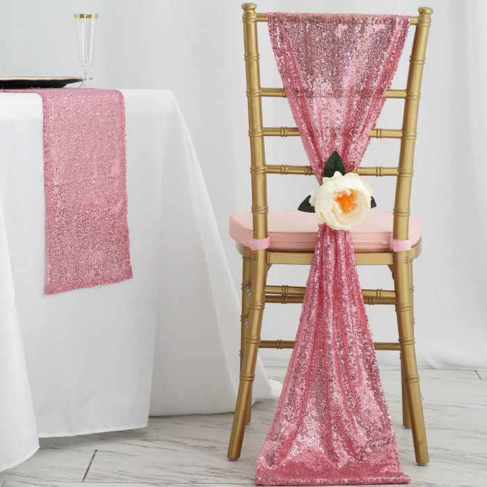 Pink sequin chair sash with flower decoration on a gold chiavari chair.