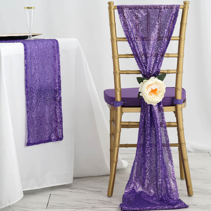 Purple sequin chair sash with flower, styled on a gold chair and table setting.