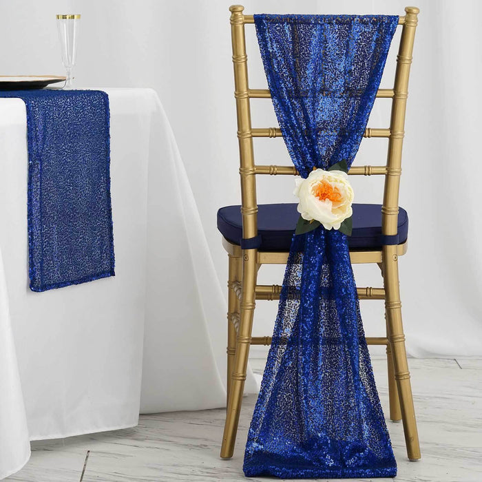 Blue sequin chair sash with flower decoration on a gold chair.