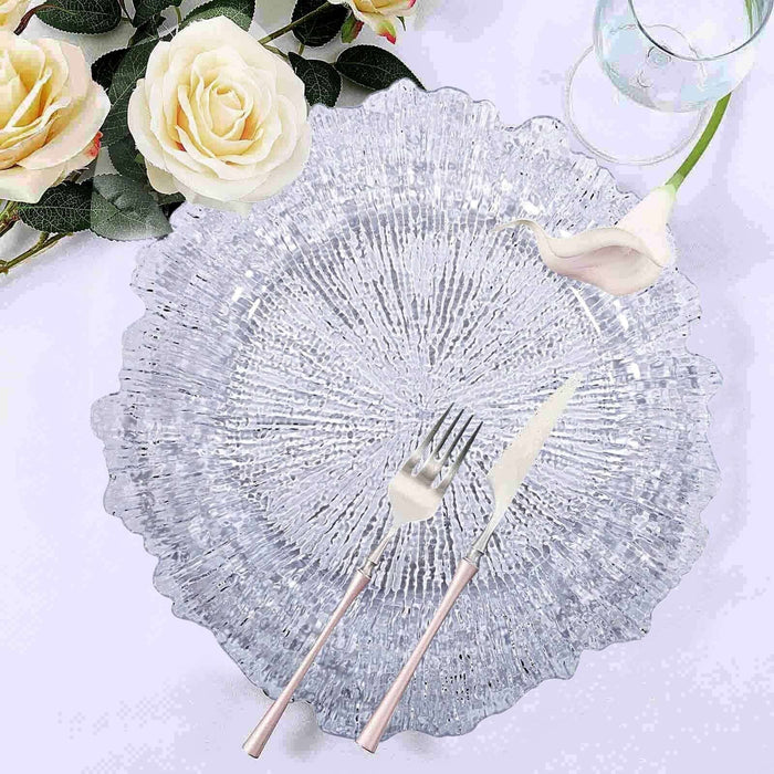 Elegant crystal plate with fork and knife, styled with roses.