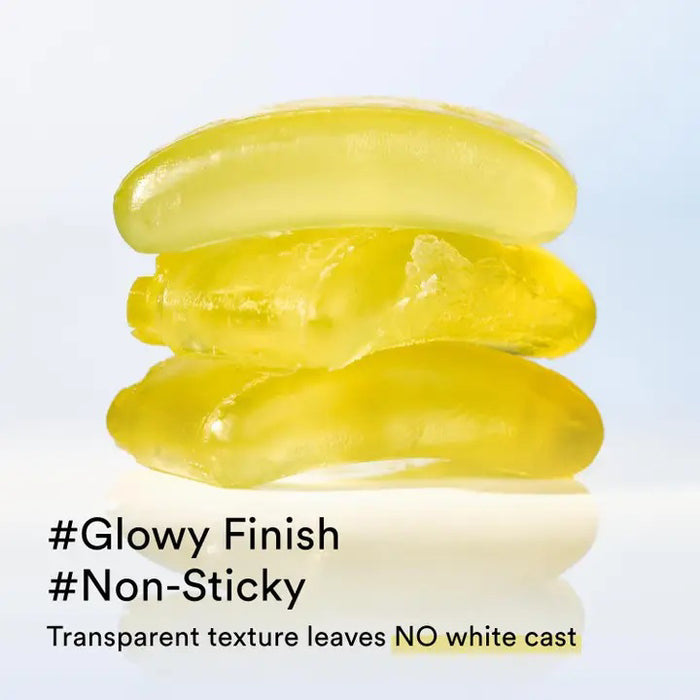 Two black ASIAN BEAUTY WHOLESALE QUICK SUNSTICK PROTECTION BAR 22G are shown: one open, revealing the pale yellow stick, the other closed. A swatch of the portable sunscreen is smeared above them on a white background.