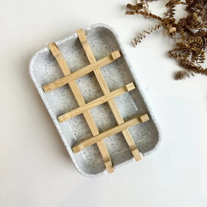 Ceramic tray with wooden grid on a light background