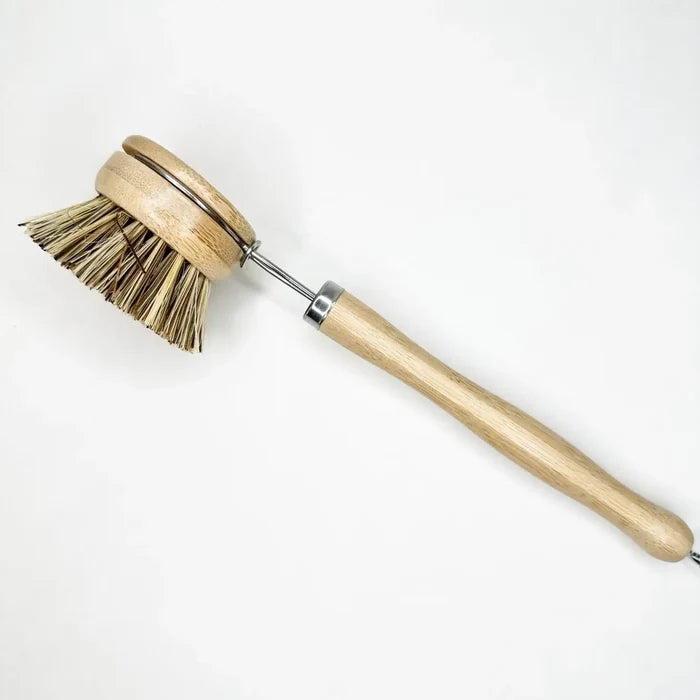 Wooden dish brush with bristle head on a white background