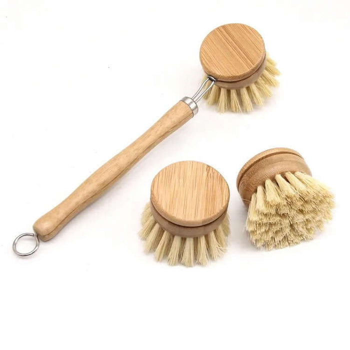 Set of three wooden dish brushes with natural bristles on a white background