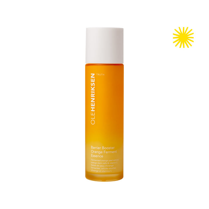 Closed bottle of Barrier Booster Orange Ferment Vitamin C Essence. Upper right hand corner has an icon of a yellow sun.