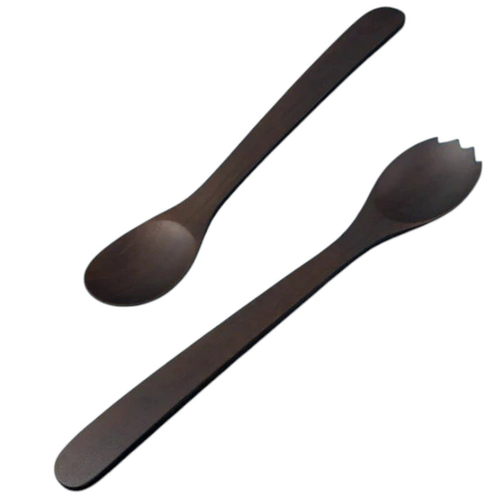 Dark wooden utensils, eggs, herbs, lemon, corn kernels, and spices are arranged neatly on a white textured surface, with the BE HOME - EBONY TEAK STREAMLINED SERVING SET by BE HOME, INC adding a touch of luxury dining. Small dark bowls surround the main items for an elegant yet inviting presentation.