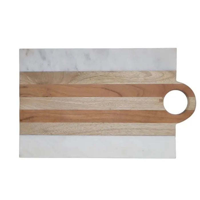 A kitchen scene with three BE HOME - MOA MARBLE & WOOD RECTANGULAR BOARDs by BE HOME, INC, paired with wine, herbs, lemon, cherry tomatoes, bread, olive oil, and spices on a beige surface—highlighting handcrafted home goods.