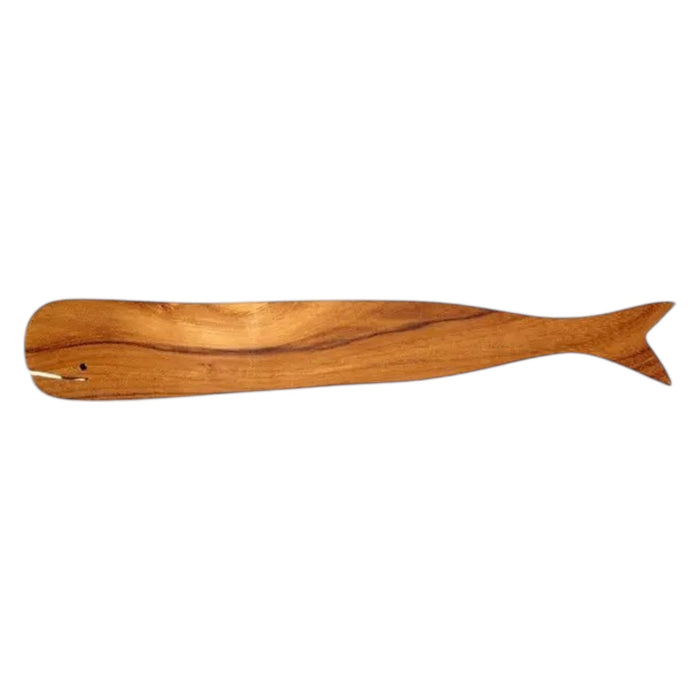 The BE HOME - TEAK WHALE SPREADERS by BE HOME, INC rest on a round white marble cutting board with a hole at the top, displayed on a wooden surface.