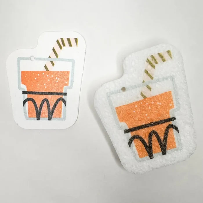 Two pot holders with a cartoonish cup design on a light gray background