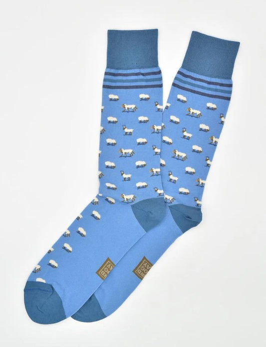 BIRD DOG BAY’s Wolf in Sheep’s Clothing Socks in Blue feature pima cotton, dark blue toes, heels, and cuffs, sheep patterns, and two dark blue stripes. Fun novelty socks to add personality to your outfit.