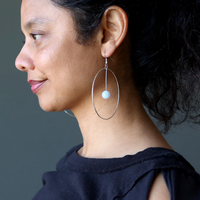 woman wearing blue calcite hoop earrings
