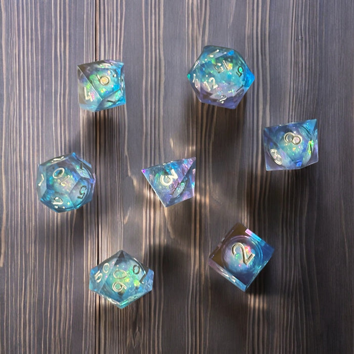 7-piece blue and purple prismatic cosmos dice set with glitter, D&D polyhedral set – Raven's Cauldron, 6 N Sandusky St, Delaware, OH 43015