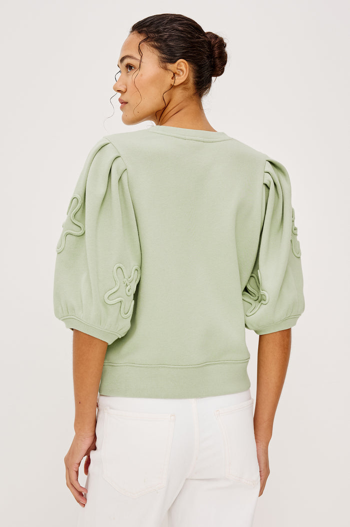 Camy Crewneck Sweatshirt in French Terry With Crew Neckline Soutached Florals and Puff Sleeves in Vintage Sage Colorway - Upper Body Back View Featured on Model