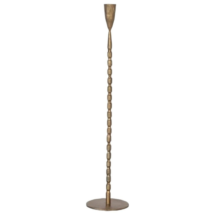 The CREATIVE COOP CAST IRON TAPER HOLDER IN BRASS FINISH, LARGE, features a tall, slender design with a textured segmented stem and round base, perfect for displaying a single taper candle.