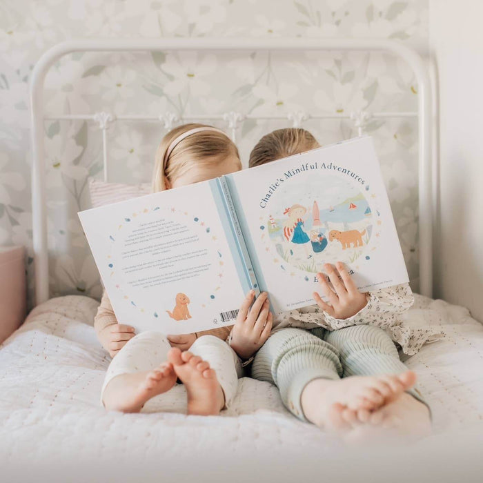 Children enjoying Charlie's Mindful Adventures By The Sea in a cozy bedroom setting.