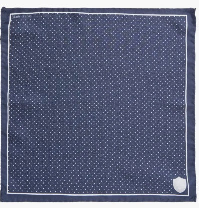 The CLIFTON WILSON - NAVY & WHITE POLKA DOT SILK POCKET SQUARE features Italian silk in navy blue, a white dot grid pattern, a crisp white border, and a "CGW" crest in one corner.