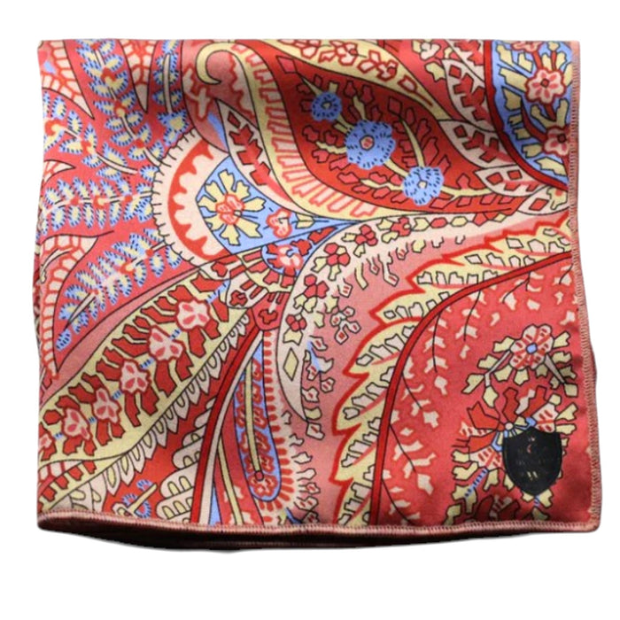 The CLIFTON WILSON - SILK PEACH PAISLEY POCKET SQUARE features a vibrant paisley design in red, orange, blue, and yellow with intricate floral and leaf motifs—a refined formal accessory from CLIFTON WILSON.