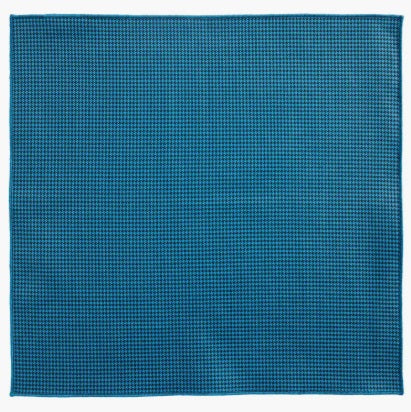 The CLIFTON WILSON Teal Houndstooth Cotton Pocket Square, made in the USA, is neatly folded and displayed on a white background.