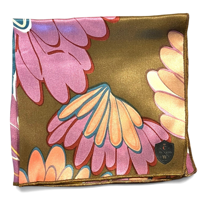 The CLIFTON WILSON Brown Floral Silk Pocket Square features a bold abstract floral print in pink, teal, coral, and brown with brown edges—a striking formal accessory for any suit.