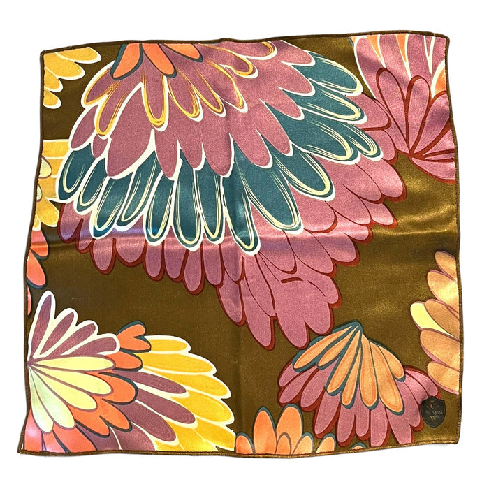The CLIFTON WILSON Brown Floral Silk Pocket Square features a bold abstract floral print in pink, teal, coral, and brown with brown edges—a striking formal accessory for any suit.
