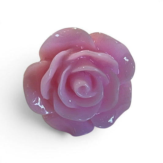 The CLIFTON WILSON - RESIN LAPEL FLOWER PIN IN PINK is a glossy, rose-shaped accessory with intricate petals, shown on a plain white background—a stylish formalwear piece by CLIFTON WILSON.