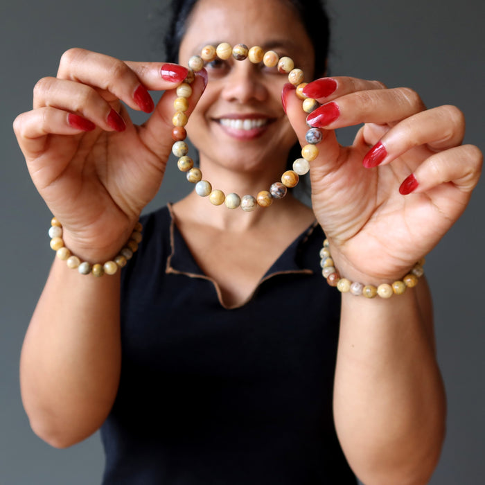 woman wearing and holding crazy lace agate bracelet