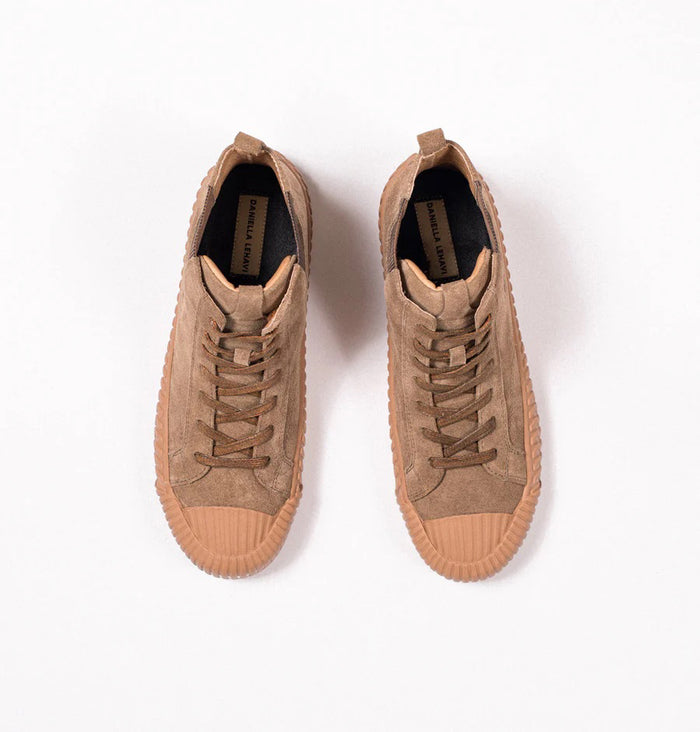 The DANIELLA LEHAVI - OSAKA HIGH TOP SNEAKER features brown suede, tan ribbed rubber soles, and side elastic panels—a stylish and comfy choice from DANIELLA LEHAVI, shown on a white pedestal against a neutral background.