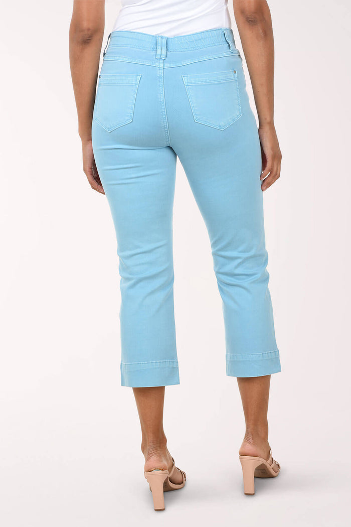 Light blue jeans worn by a person on a white background. Back shot