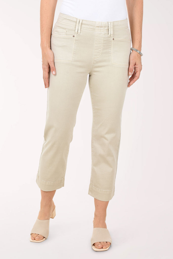 Person wearing beige pants on a white background