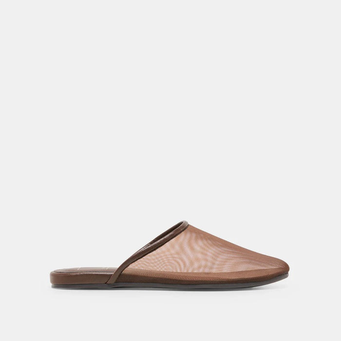 The DOLCE VITA - GENI Mesh Flats in Chocolate are chic brown slip-on mules with a low heel and flat sole, inspired by ballet flats, shown against a light gray background.