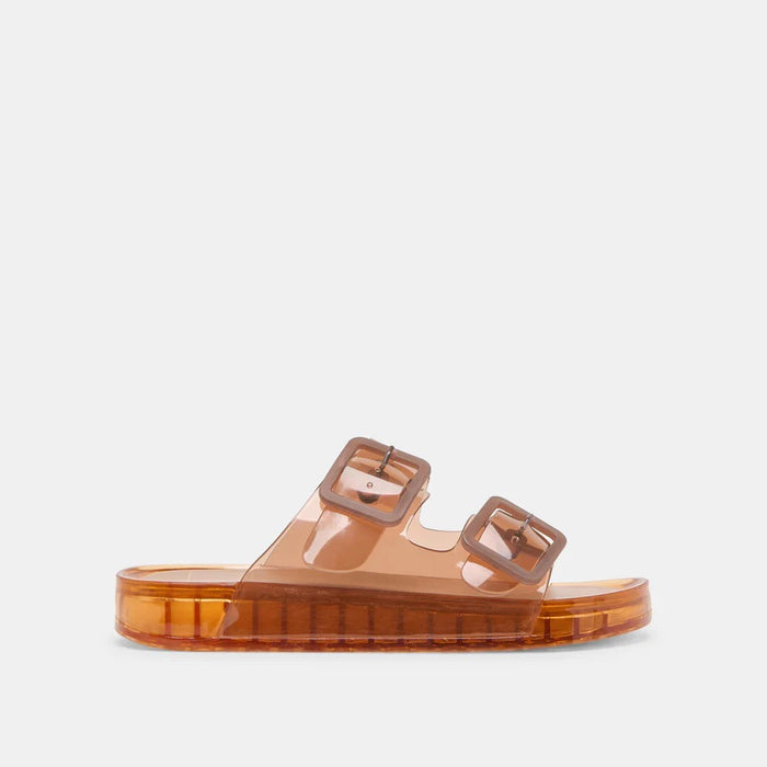 The DOLCE VITA - JULIO WHISKEY SANDAL by DOLCE VITA is a translucent orange jelly sandal with two wide straps, bold matching buckles, and a flat chunky sole for a simple, modern look.