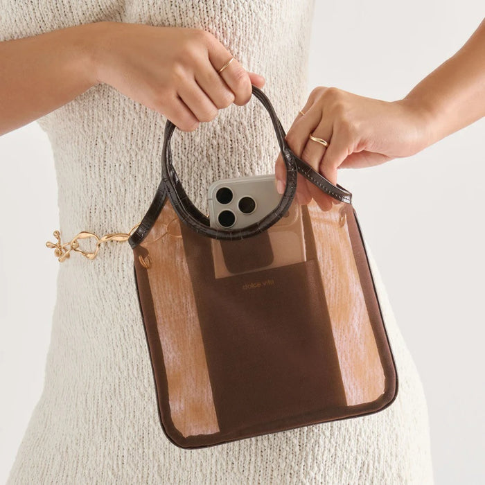 The DOLCE VITA - SYLVENE CROSSBODY MESH BAG IN CHOCOLATE features a chic square silhouette with brown stripes, rounded handles, and a gold chain strap, shown against a plain white background.