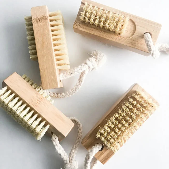 Set of wooden scrub brushes with natural bristles on a light background