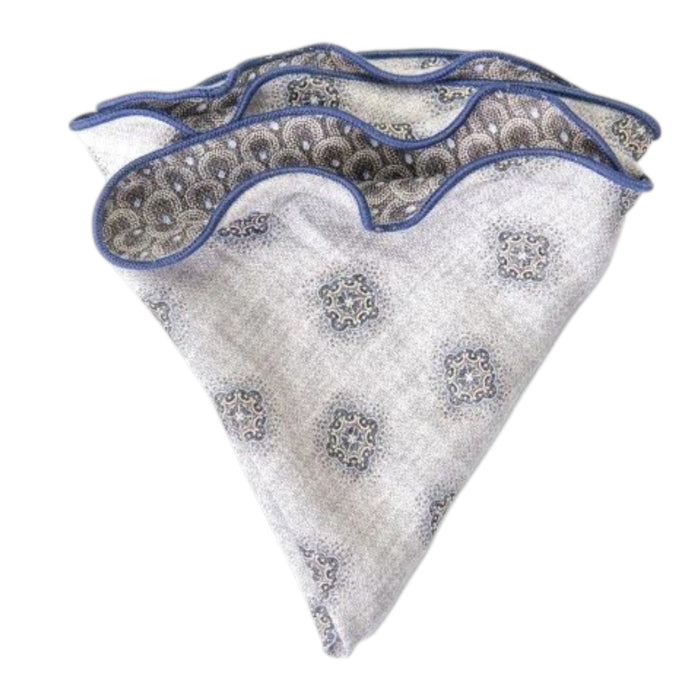 The EDWARD ARMAH Silk Reversible Pocket Circle in Gray Foulard/Feather features a light gray geometric pattern with blue accents and border, shown folded on a white background.