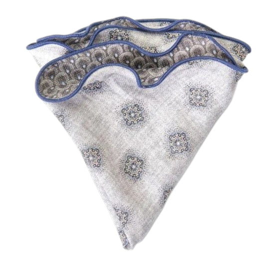 The EDWARD ARMAH Silk Reversible Pocket Circle in Gray Foulard/Feather features a light gray geometric pattern with blue accents and border, shown folded on a white background.