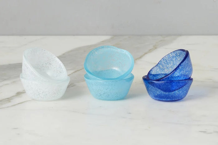 Six handcrafted ETUHOME Glass Pinch Pots in white, light blue, and dark blue are stacked on a white marble surface.