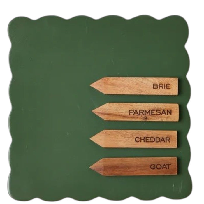 The ETUHOME Green Square Scalloped Cheese Board with Markers displays six savory herb tarts arranged in a circle around a glass dip bowl, resting on a beige napkin with two forks on a marble surface.