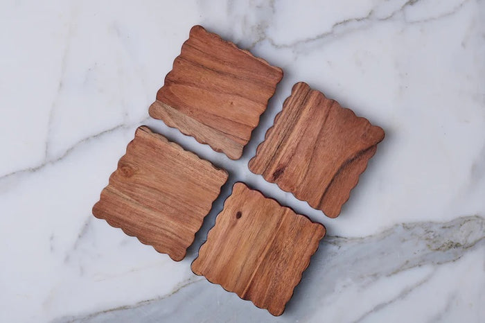 The ETUHOME Scalloped Wood Coasters, Set of 4, features square coasters with wavy scalloped edges, neatly stacked atop each other against a white background.