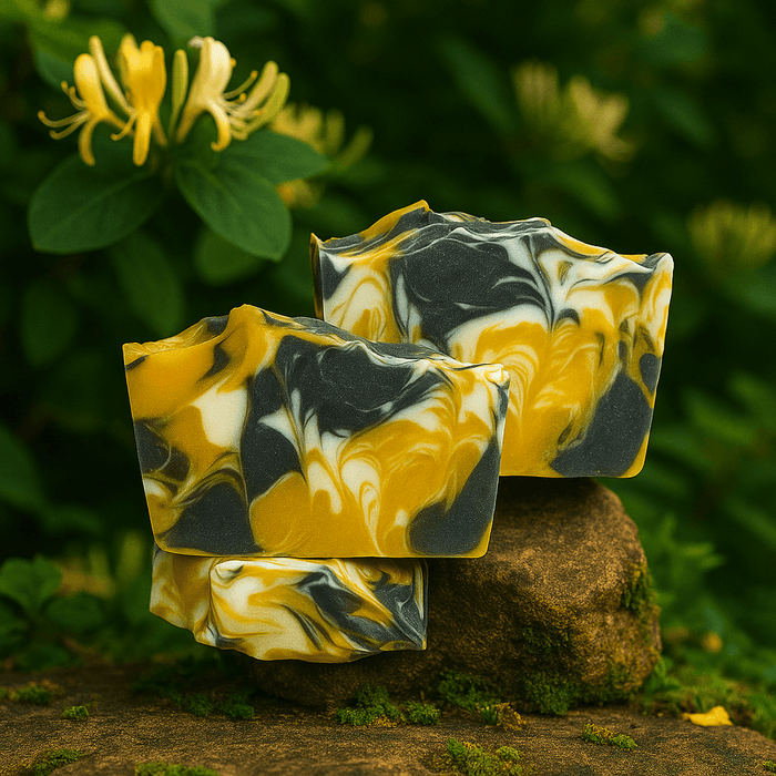 Evening Honeysuckle Bar Soap - Soap Boutique with golden yellow and charcoal swirls, set against a garden backdrop.