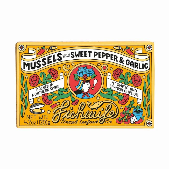 A vibrant box of FISHWIFE Mussels with Sweet Pepper & Garlic showcases decorative illustrations, stylish text, and a central figure holding a fish, emphasizing these artisanal canned mussels as premium seafood packed in Spain.