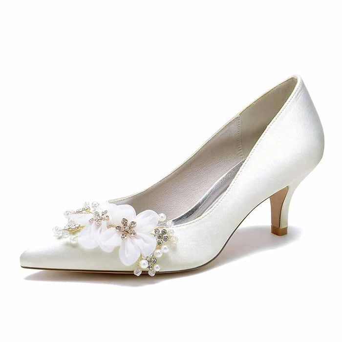 Elegant white heels with flower embellishments, perfect as flower embellished wedding shoes for bride